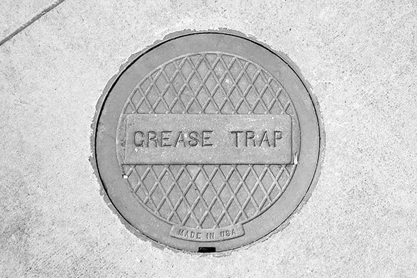 neglecting grease trap pumping can lead to clogs, backups, and potential fines from local health departments for non-compliance with regulations